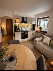 a kitchen and living room with a table and a couch at Appartement Wanneck in Biberwier