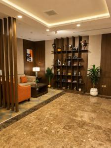 a living room with a couch and a table at فندق امان أبها - المحالة in Abha