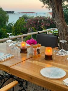 a wooden table with two lights on top of it at The Bay View Hotel Kalkan in Kaş