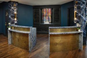 a lobby with blue walls and a stained glass window at The William Fell Baltimore, Tapestry Collection by Hilton in Baltimore