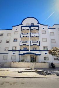a large white building with blue balconies on it at Mivô - Alcochete Views & Comfort in Alcochete