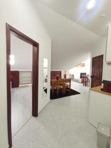 a room with a kitchen and a dining room at Mivô - Alcochete Views & Comfort in Alcochete