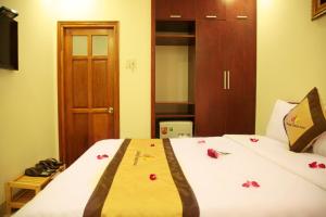 Rúm í herbergi á Danang Classic Hotel
