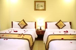 Rúm í herbergi á Danang Classic Hotel