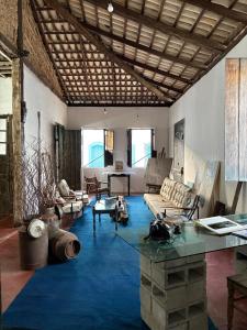 a large living room with a couch and a table at Casa Beco do Sertão - Praça do Coreto in Goiás