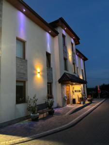 a large white building with lights on it at night at Villa Laguna in Rewa