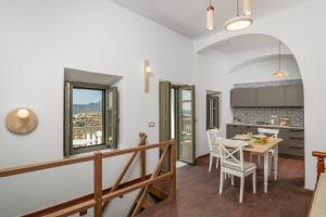 a kitchen and dining room with a table and chairs at Astraea in Tripiti