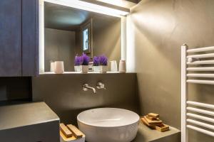 a bathroom with a white toilet and a mirror at Astraea in Tripiti +31 photos