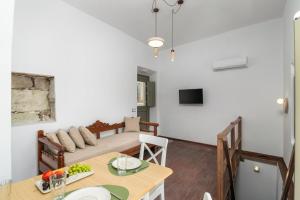a living room with a table and a couch at Astraea in Tripiti