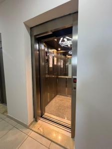 an elevator in a building with a glass door at Résidence Luna in Oran