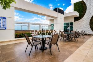 a patio with tables and chairs in a building at THE VIEW AT RIVEFRONT by Bahama Rentals in Guayaquil