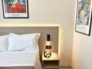 a bedroom with a bed and a phone on a night stand at Hotel Molise 2 in Milan