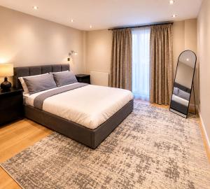 a bedroom with a large bed and a large window at Spacious 3BR Lancaster Gate Near Hyde Park in London