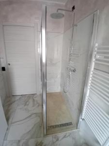 a shower with a glass door in a bathroom at Valentina GuestHouse in Sestu
