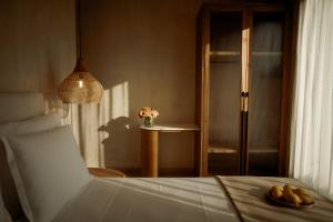 a bedroom with a bed and a table with flowers at Manas Villas in Elaiokhórion
