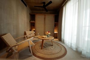 a living room with a table and chairs and a window at Manas Villas in Elaiokhórion