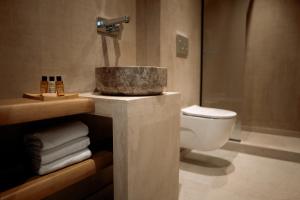 a bathroom with a sink and a toilet and towels at Manas Villas in Elaiokhórion +11 photos