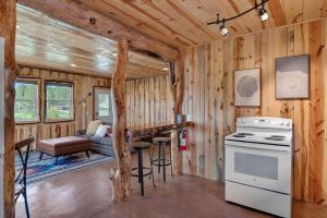a kitchen and living room in a log cabin at Sun Filled Joy BHBungalows #8 in Custer