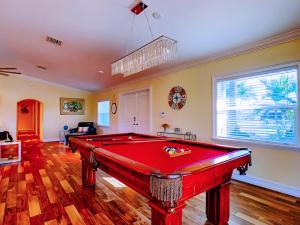 a living room with a red pool table in it at 20 Disc-2 Kg Mstrs, Golf, Fishing, BBQ, Pool, Spa in Cape Coral