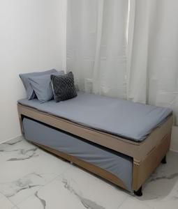 a bed with two pillows on it in a bedroom at Apartamento próximo a Lagoa do Perola in Governador Valadares