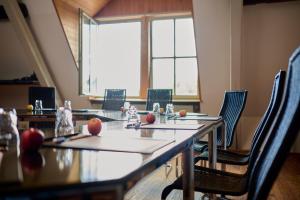 a room with tables and chairs and a large window at Restaurant & ****Hotel HÖERHOF in Idstein
