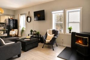 a living room with a couch and a chair and a fireplace at Detente Namur in Namur