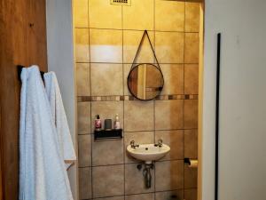 a bathroom with a sink and a mirror at The Neighborhood Haven in Richards Bay +14 photos