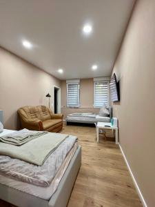 a bedroom with a bed and a couch and a table at Apartment Marin in Bad Wildbad
