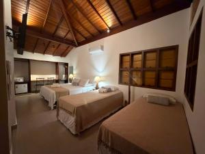 a hotel room with two beds in a room at Pousada Arraial Candeia in Arraial d'Ajuda +131 photos