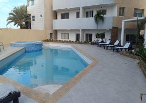 a swimming pool in front of a building at Yaque Breeze - Beach Apartament in El Yaque