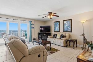 a living room with a couch and a tv at Waterfront Views & Beach Access - pet friendly in Navarre