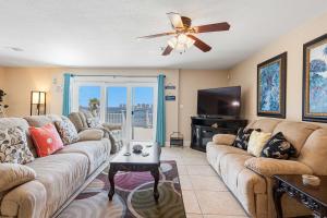 a living room with a couch and a flat screen tv at Waterfront Views & Beach Access - pet friendly in Navarre