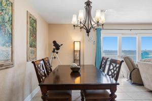 a dining room with a table and a camera at Waterfront Views & Beach Access - pet friendly in Navarre