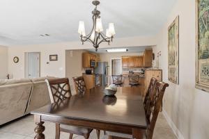 a dining room and kitchen with a table and a couch at Waterfront Views & Beach Access - pet friendly in Navarre +36 photos