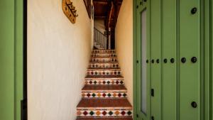 a staircase in a building with green doors at Casa Nazari in Benaocaz