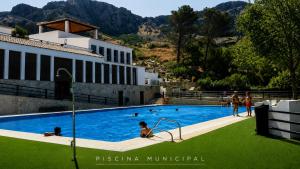 a group of people swimming in a swimming pool at Casa Nazari in Benaocaz