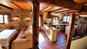 a living room with a couch and a kitchen at Casa Nazari in Benaocaz