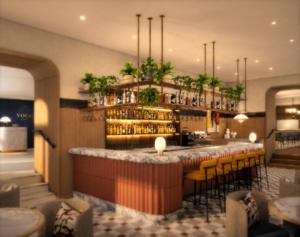 a bar in a restaurant with yellow chairs at voco London - Bloomsbury by IHG in London