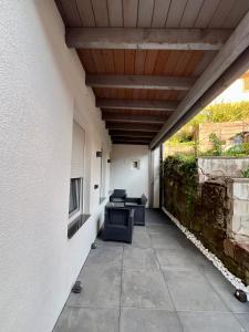 a patio with two chairs and a wooden ceiling at Apartment Marin in Bad Wildbad