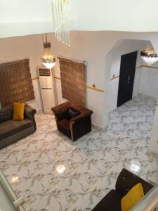 a living room with couches and a marble floor at Four bedroom duplex in Lagos