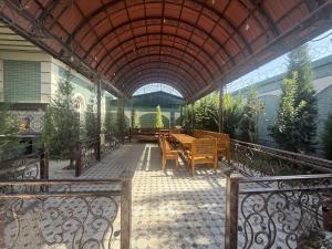 a patio with a table and chairs in a building at Dacha by Bex Sueno in Samarkand