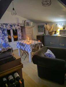 a living room with a table and a couch at L Empreinte in Saint-Juvin