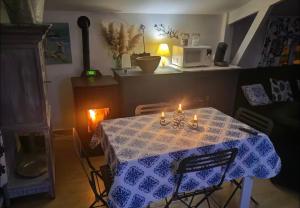 a dining room table with a blue and white table cloth at L Empreinte in Saint-Juvin