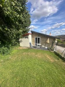 a house with a lawn in front of it at L Empreinte in Saint-Juvin