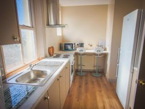 a small kitchen with a sink and a microwave at East Bridge House in Enniskillen