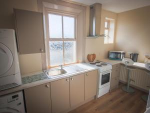 a kitchen with a sink and a stove and a window at East Bridge House in Enniskillen +20 photos