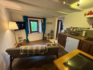 a kitchen and living room with a couch and a table at Valley View Apartment in Kambreško
