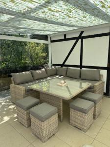 a patio with a table and cushioned chairs at Ferienwohnung Taunusnest in Limbach