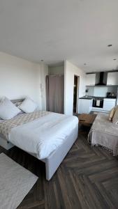 a hotel room with two beds and a kitchen at Chez Lima in Lorient