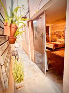 a bathroom with a sliding glass door and a bedroom at Body & Mind Beautiful - Suites Elegantes e Charmosas in Franca